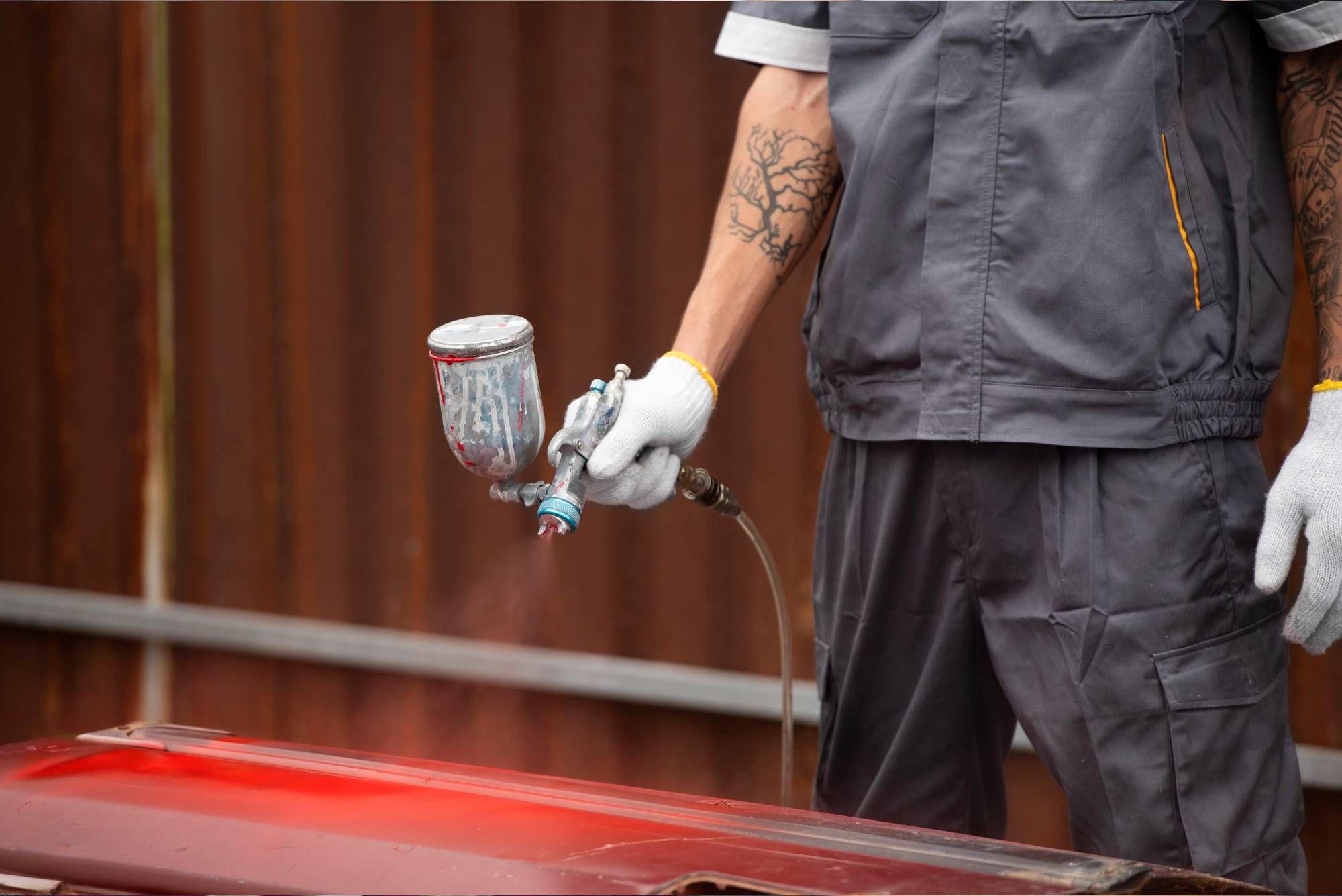 Man painting car door side view